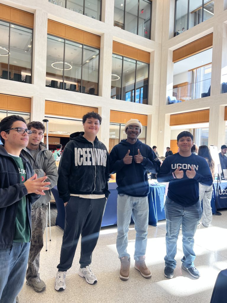 four students posing together
